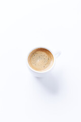 Cup of coffee on bright paper background. Copy space.	
