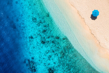 Umbrella on the beach. Beach and sand background from top view. Aerial seascape. Summer seascape from air. © biletskiyevgeniy.com