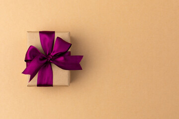 Box wrapped in craft paper on craft paper background