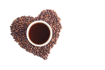 The concept of love for coffee. A yellow paper cup of coffee among coffee beans folded in the shape of a heart, on a white isolated background.