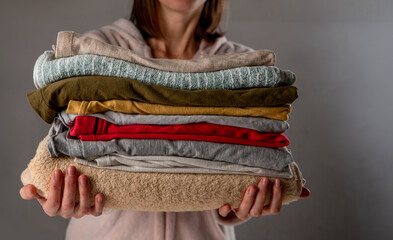 Stack of clothes in female hands