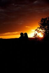 Silhouette of couple in love on sunset background