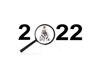 2022. business concept. planning 2022. magnifier with a drawing of a business christmas tree.