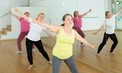 Fototapeta premium Happy adults training swing steps at dance class