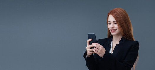 Fototapeta premium Beautiful smiling Turkish young woman, mobile phone concept. She is checking her mobile phone.