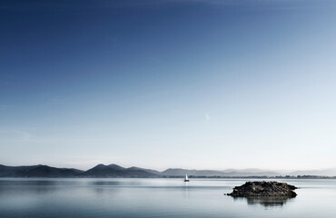 Sail boat on the waters of Lake Trasimeno , Italy