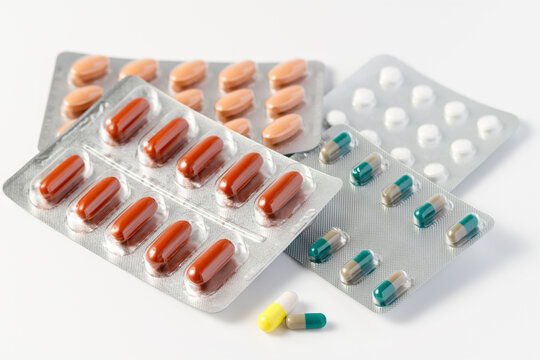 Blister packs with medicines in the form of capsules and tablets on white
