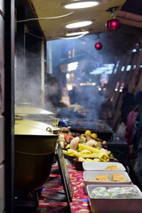 food, treats on the street on New Year's Eve. Christmas in the square. hot mulled wine in cauldrons, and a lot of food, a holiday, a festival. New Year's market at Vorosmarty square in center of city