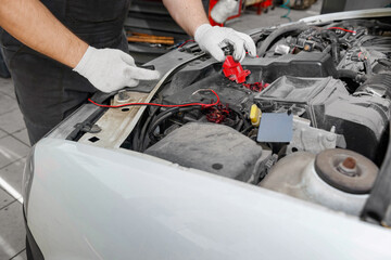 Mechanic repairing engine on a car using wrench. Close up of hands