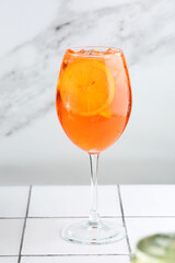 aperol spritz closeup with sliced orange. traditional Italian alcoholic cocktail aperol on bar counter on a light background