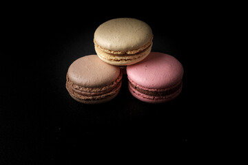 Three macarons with black background