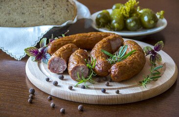 Tasty sausages and vegetables isolated over solid background