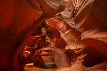 Famous Antelope Canyon near Page in Arizona. Beautiful colored and luminous sandstone walls shine through the warming rays of the sun shining through the rocks canyons.