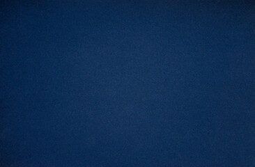 Fototapeta premium A blank blue sheet of paper. Space for text on a blue background. Dark blue shade of craft paper. The background is blue.