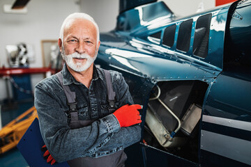 Portrait of professional senior helicopter mechanic who works in air vehicle repair service. © hedgehog94