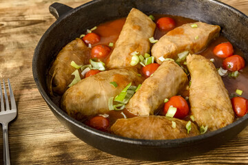 stuffed cabbage, rice and minced meat with tomato sauce