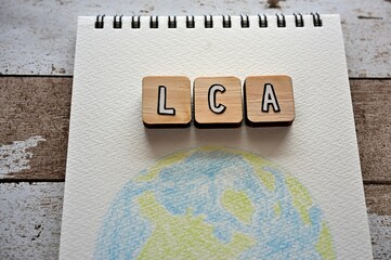 The letters arranged in the word LCA It's an abbreviation for Life Cycle Assessment. It's on a...