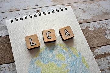 The letters arranged in the word LCA It's an abbreviation for Life Cycle Assessment. It's on a...