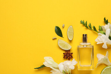 Flat lay composition with bottle of perfume and fresh citrus fruits on yellow background. Space for text - obrazy, fototapety, plakaty