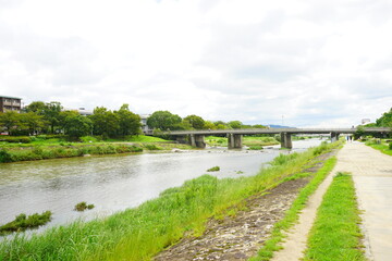 Fototapeta na wymiar Trail along Kamo River or Kamogawa in Kyoto, Japan - 京都 鴨川 賀茂川