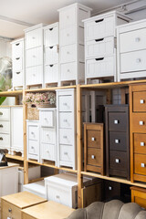 Shelf with wooden chests of drawers for sell in a furniture store