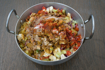 Indian delicious home made chaat of chickpeas, tomatoes, fruits, masalas in aluminium wok
