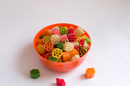 raw fryums in an orange bowl in isolated white background