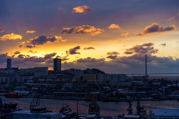 Fototapeta na wymiar Dramatic sunrise over the Diomid port. Vladivostok