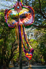 Vibrant colored and unique shaped masks displayed along the city streets in Panaji city during Goa Carnaval in Goa, India.  - obrazy, fototapety, plakaty