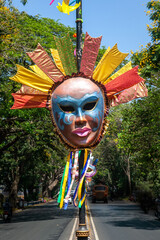 Vibrant colored and unique shaped masks displayed along the city streets in Panaji city during Goa Carnaval in Goa, India.  - obrazy, fototapety, plakaty
