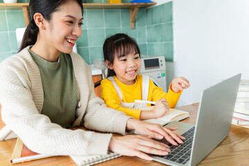 Asian Mother and daughter studying together at home