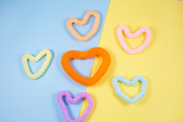 Multicolored bright plastic corrugated tube in the form of heart