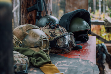 protective armored helmets in camouflage livery lie on the gun table
