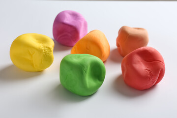 Different color play dough on white background