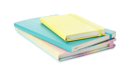 Stack of different colorful hardcover planners on white background