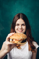 cheerful woman eating hamburger snack close-up lifestyle