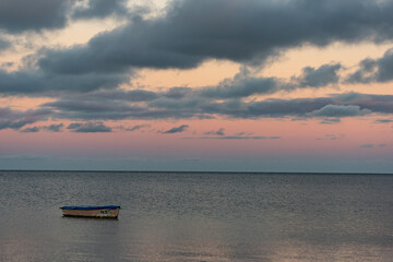 Fototapeta premium Solitary boat dawn seascape