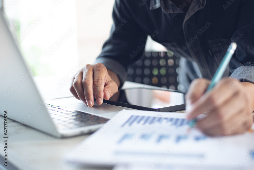 Aufkleber business man working at office with laptop computer and digital tablet and financial report graph da