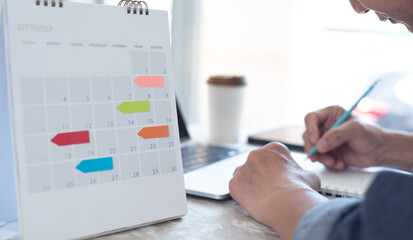 Planner or organizer plan daily schedule on 2022 calendar event planner. Asian business man planning work schedule. Calendar reminder event concept