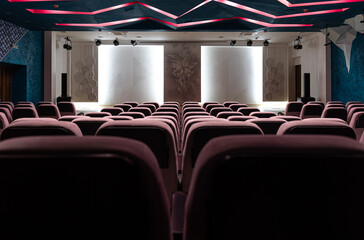 Interior of an empty concert hall with colored lighting.