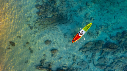 Fototapeta na wymiar Aerial view of a kayak in the blue sea .Woman kayaking She does water sports activities.
