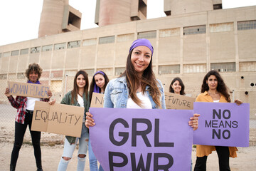 Smiling feminist with a banners at a protest. Happy demonstration.