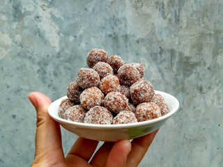 Tamarind candy, placed inside white small plate. Sweet and sour candy made from tamarind paste and...