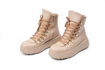 Womens beige leather boots with zip and lacing, photographed against a white background.