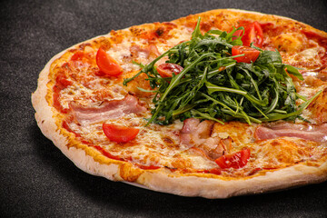 Pizza with bacon and rucola