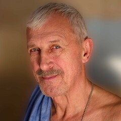 Fototapeta premium An aged man in the bathroom with a towel