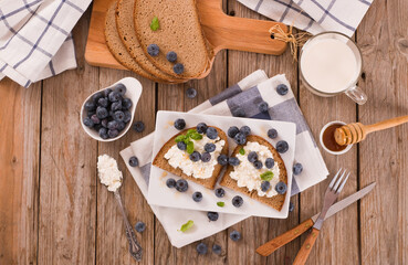 Rye bread with cottage cheese, blueberries and honey.