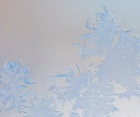 Snowflakes on glass as a background.