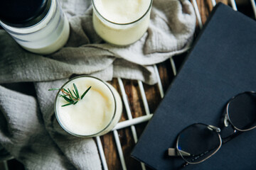 Corn juice smoothie on a white sieve on the side with glasses, book prop Place on wood table. Top view