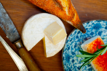 French cheese and fresh  baguette on a wood cutter